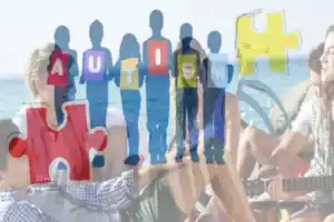 Group of people with puzzle pieces spelling 'Autism' at outdoor event.