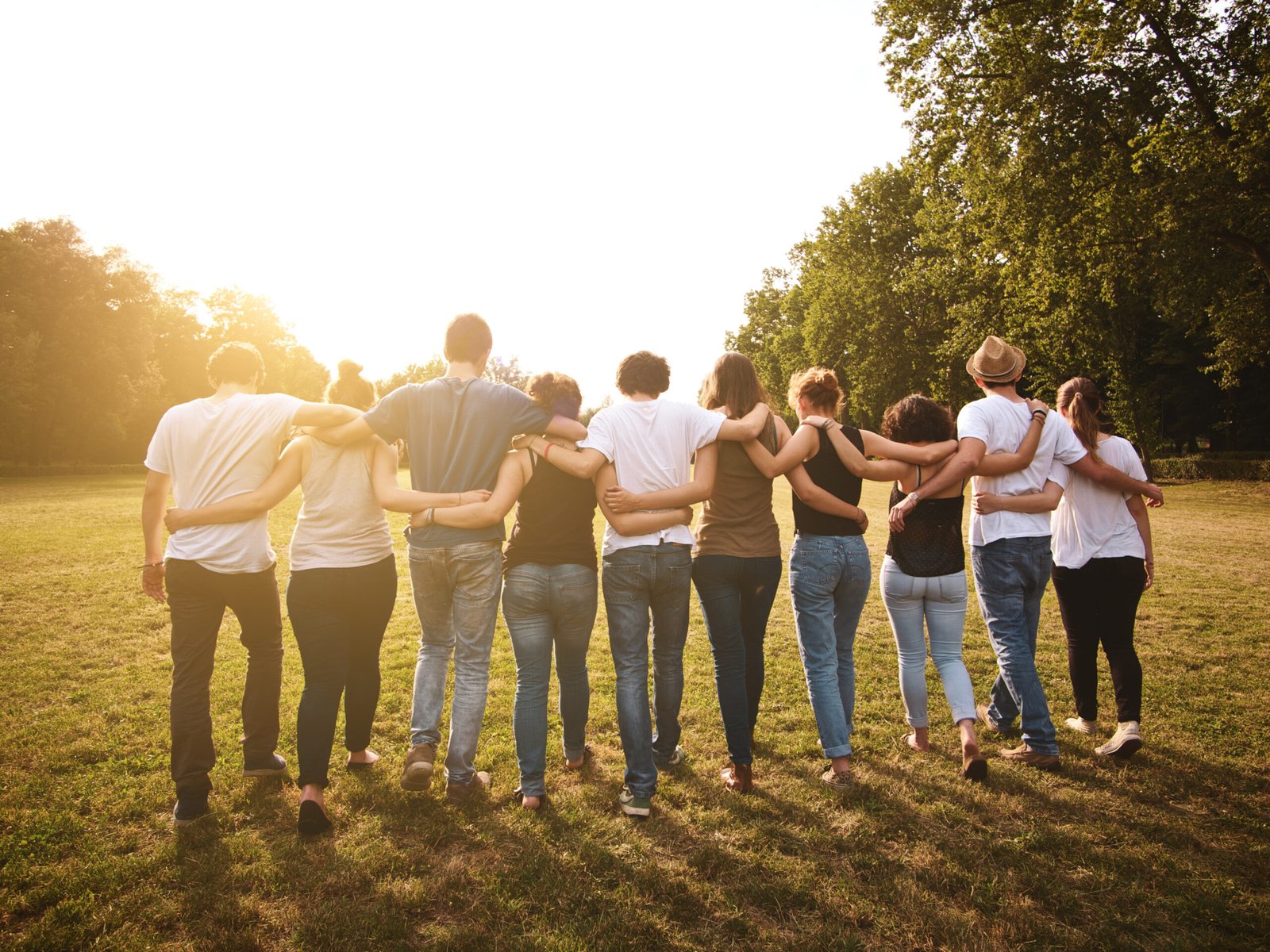 large group of friends enjoying a summer day at the park, back to school Discover More Supportive Community